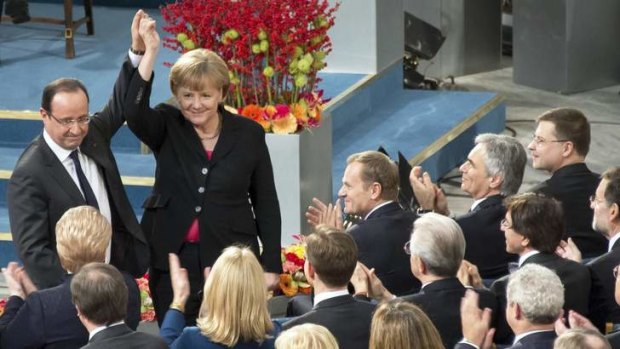 Bon accord: French President Francois Hollande and German Chancellor Angela Merkel show solidarity during the Nobel peace price ceremony in Oslo.