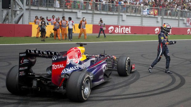 Red Bull driver Sebastian Vettel of Germany celebrates after winning the Indian Formula One Grand Prix and his 4th straight F1 world championship.