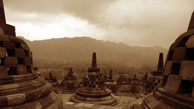 Lotus pose ... towering mountains frame the stupas and statues of the Borobudur temple in Java.