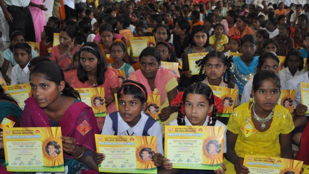 Indian girls hold up their name change certificates during a ceremony in Satara, 250 kilometres from Mumbai.