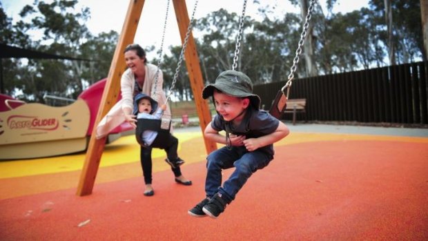 Child's play: Kathryn Smith, of Bruce, enjoys the Boundless Canberra playground with children, from left, Henry, 1, and Owen, 2.