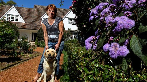 ''The garden is an integral part of the Hathaway experience.'' ... Jen Rhynehart and her dog, Rolly, at her home at Warrawee which is up for sale. Gardens are sought after features.