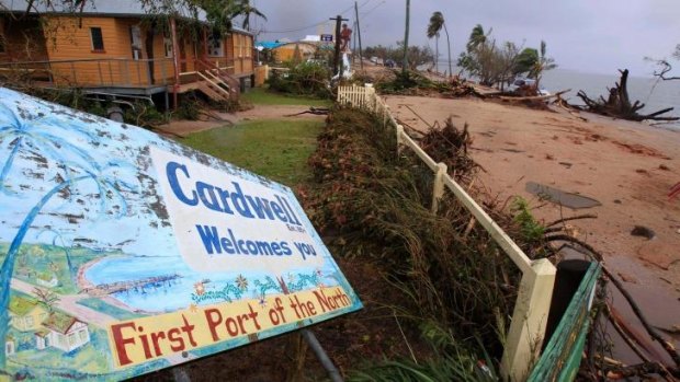A welcome sign is knocked down by Cyclone Yasi in Cardwell.