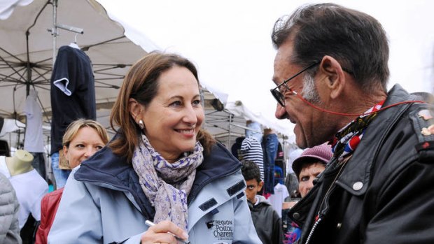 French parliamentary election candidate Segolene Royal greets locals at a market.