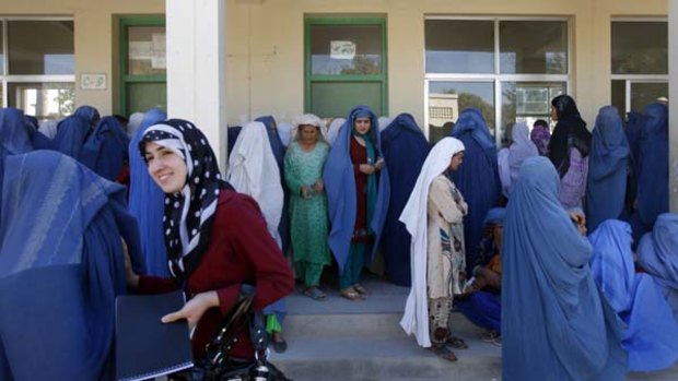 Afghan women line up at a polling station.