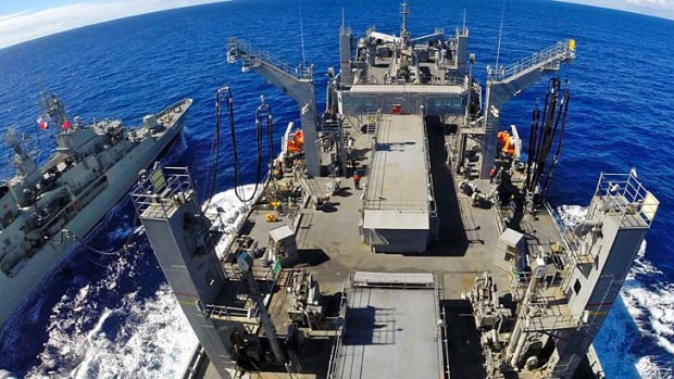 Support: A US ship helps resupply HMAS Toowoomba.