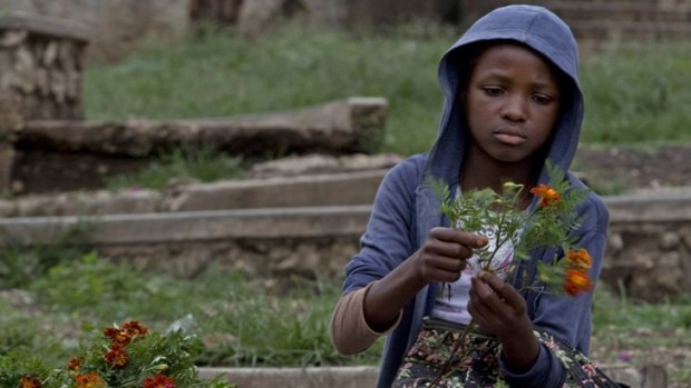 Growth ... Esperanta Michel, 13, prepares fresh flowers to sell to parishioners on Sunday.