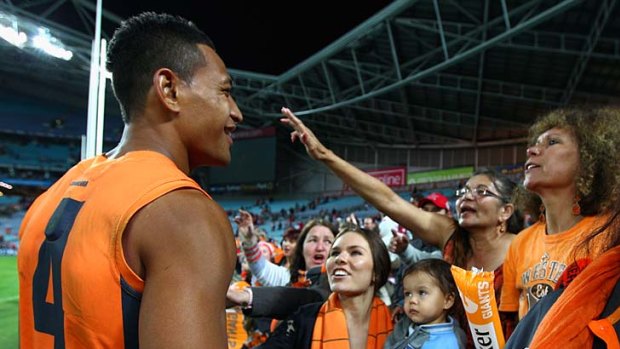 Giant among fans: Israel Folau acknowledges the GWS fans after the game against the Swans last Saturday night.