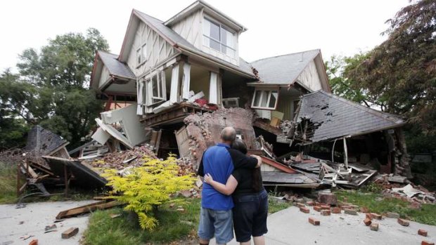 A couple in front of their damaged home in Christchurch after the 2011 earthquake.