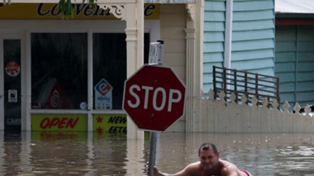 Wet commute ... paddling in Hoogley Street, West End.