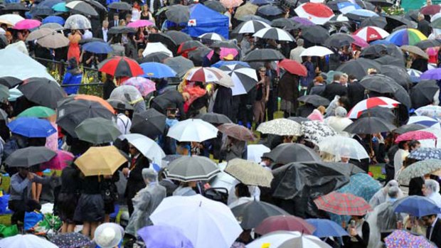 Sea of umbrellas ... a heavy downpour has caused chaos at the Melbourne Cup.