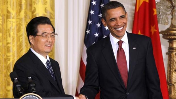 US President Barack Obama, right, and Chinese President Hu Jintao shake hands at the conclusion of their joint news conference.