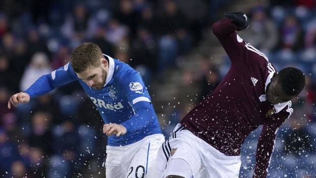 Rangers' Kyle Hutton, left, and Hearts' Prince Buaben Abankwah in action.