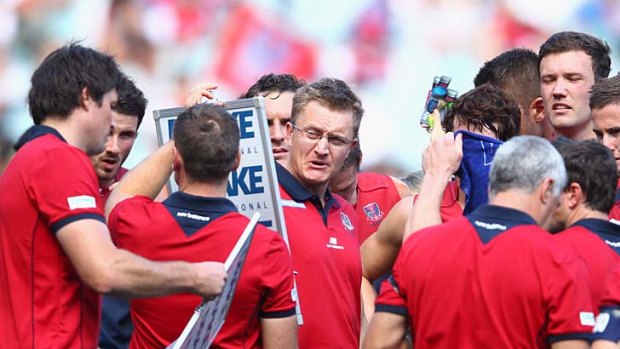 Demons coach Mark Neeld talks to his players during the round one match against Brisbane.