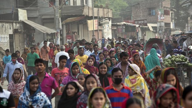 Garment workers walk to their factories in Dhaka earlier this month. 