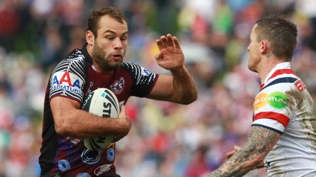 Strong sense of direction ... Manly's fullback Brett Stewart prepares to fend off Todd Carney.