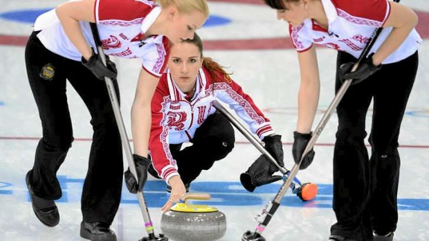 Ice queens: Russia's Anna Sidorova (C) throws the stone as her teammates Ekaterina Galkina (R) and Alexandra Saitova sweep the ice during the Women's Curling.