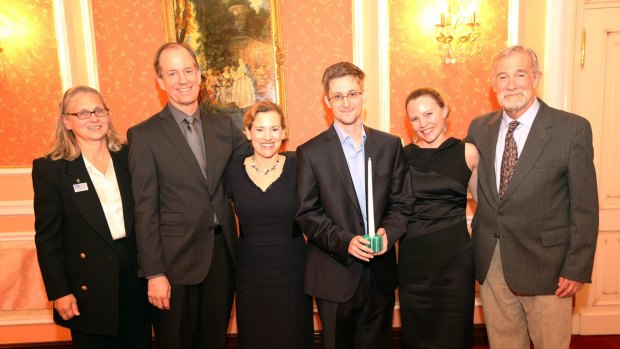 Snowden receiving the Sam Adams Associates for Integrity in Intelligence Award (SAAII) alongside UK WikiLeaks journalist Sarah Harrison (second from right) who took Snowden from Hong Kong to Moscow and obtained his asylum, and the United States government whistleblowers who presented the award, Coleen Rowley (FBI), Thomas Drake (NSA), Jesselyn Raddack (Department of Justice) and Ray McGovern (CIA) in October 2013 in Russia. 