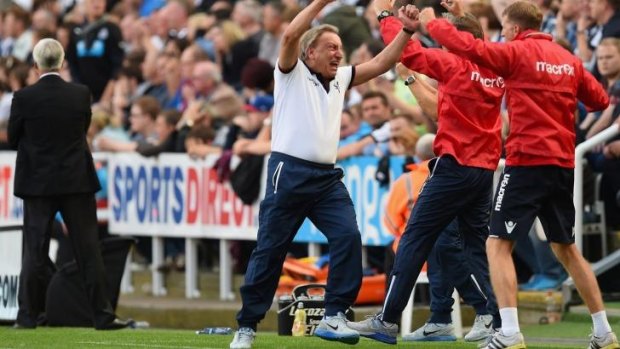 Manager Neil Warnock of Crystal Palace turns to celebrate with his coaching staff after Wilfried Zaha of Crystal Palace scores the equaliser against Newcastle.