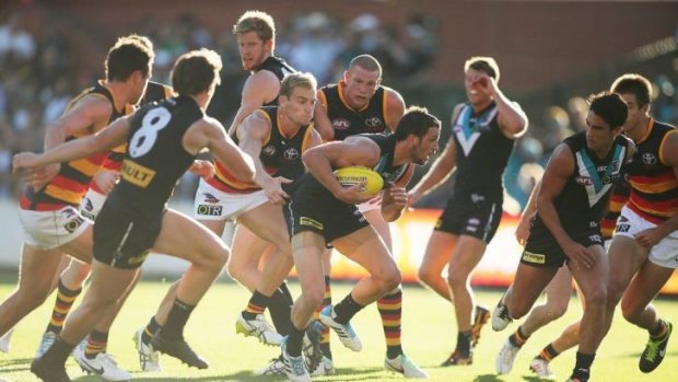 Travis Boak of the Power powers through a group of players.