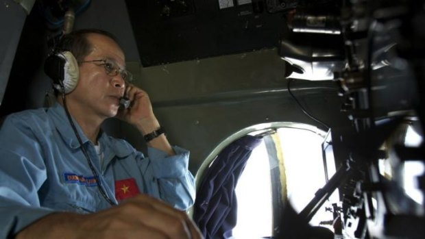 Vietnam air force Colonel Duong Van Lanh looks at the navigation control panel aboard aircraft Antonov An-26 during a search mission for the missing Malaysia Airlines Boeing 777 over water between Malaysia and Vietnam.