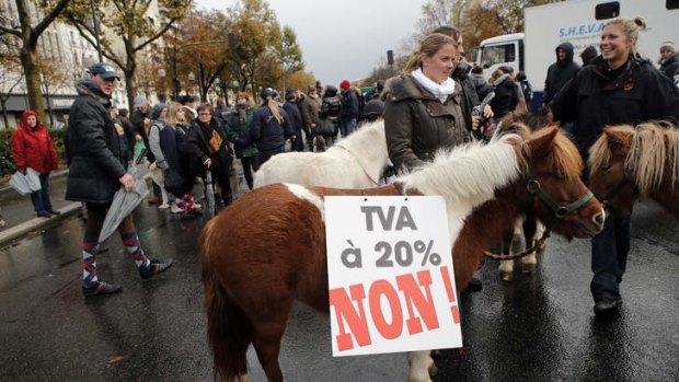 Champing at the bit: Horses and ponies and their owners filled Bastille Square in Paris on Armistice Day to demonstrate against the planned tax increases.