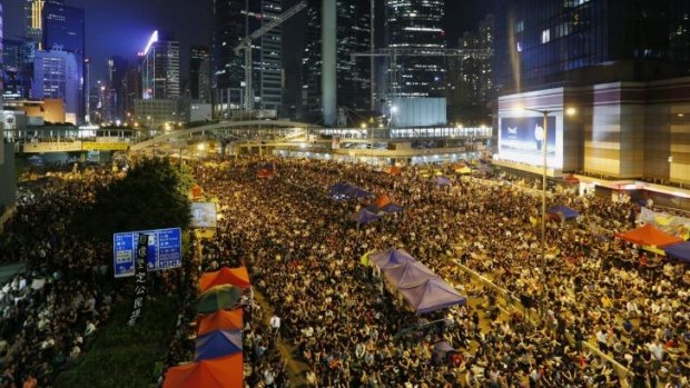 Rally: Pro-democracy protesters block a main road outside government headquarters in Hong Kong on Saturday.