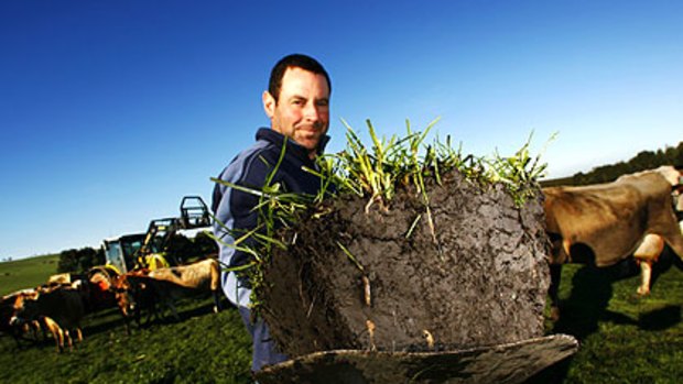 Doing the ground work: Timboon dairy farmer Darryn Smith has switched to a biological fertiliser that is improving his soil, luring the worms and reducing his vet bill. It's also storing carbon.