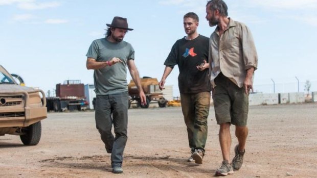 Dirty old town: Director David Michod (left) on the set of <i>The Rover</i> with Robert Pattinson (middle) and Guy Pearce.