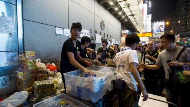 Stocking up for the long haul ... People give away water and food to protesters in the Mong Kok district of Hong Kong.