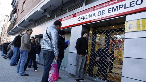 Disquieting: unemployed workers wait outside a government job centre in Madrid.