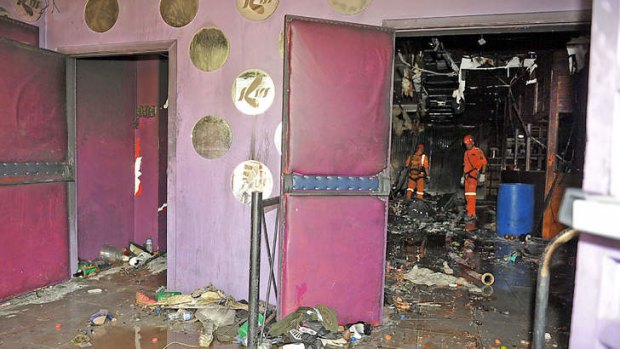 Rescue workers investigate Kiss nightclub.
