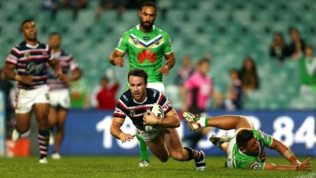 Roosters five-eighth James Maloney dives over against the Raiders.