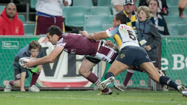 Try time: Manly's Michael Oldfield, crosses for the Sea Eagles' first try against North Queensland last night.