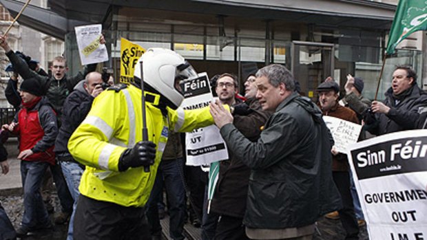 Sinn Fein demonstrators clash with police officers after breaking through the gates of Government Buildings, in Dublin.