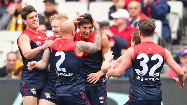 The Demons get around first-gamer Sam Weideman after he kicked a goal with his first kick in the AFL.