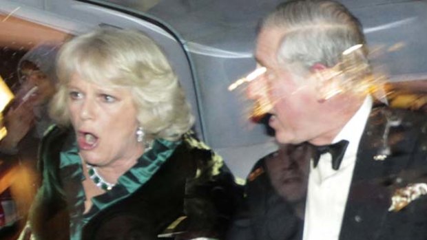 Prince Charles and Camilla, Duchess of Cornwall, react as their car is attacked by angry protesters in London.