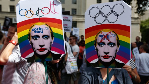 Activists holding placards depicting Russian President Vladimir Putin, participate at a protest against Russia's new law on gays.