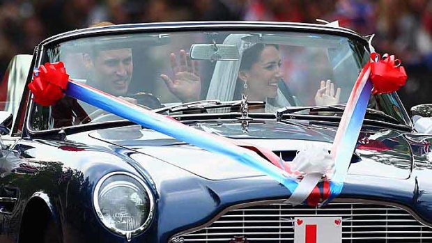 The royal couple driving Prince Charles's Aston Martin - complete with jokey L-plate.