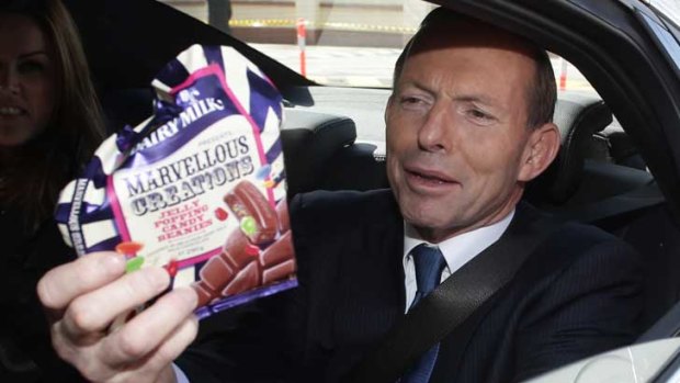 Tony Abbott leaves the Cadbury factory with a sample..