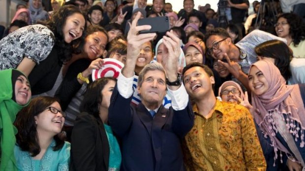 US Secretary of State John Kerry takes a selfie with students before delivering his speech.