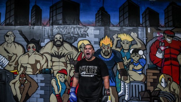 UFC fighter Mark Hunt in his Minto gym, backed by his video game heroes.
