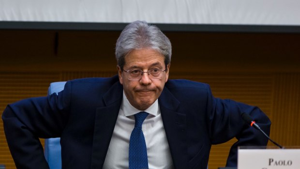 Italian PM Paolo Gentiloni prepares to leave at the end of a year-end press conference in Rome on Thursday.