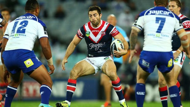 Anthony Minichiello of the Roosters runs the ball.
