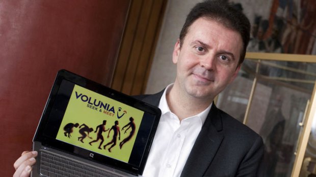 Italian computer science professor Massimo Marchiori poses with a laptop showing his new site entitled "Volunia".