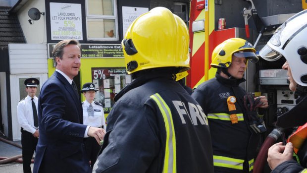 British Prime Minister David Cameron visits Croydon to view the destruction.