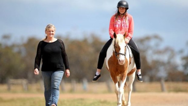 Christine Dennison with her granddaughter Krystal riding their horse Katie.