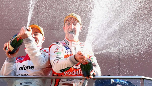 Jamie Whincup, right, celebrates his win last year.