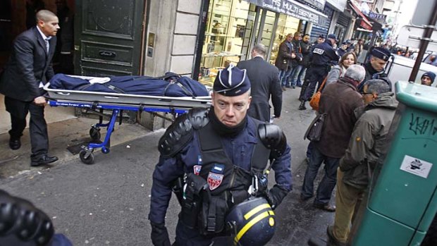 One of the three bodies of the killed Kurdish women is taken out of the building in Paris.