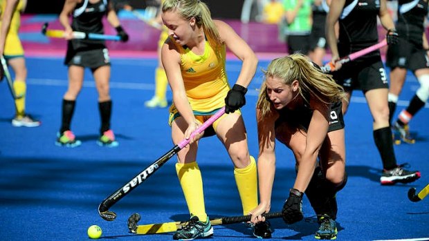 Australia's Emily Smith battles New Zealand's Clarissa Eshuis in their Olympic hockey pool match.